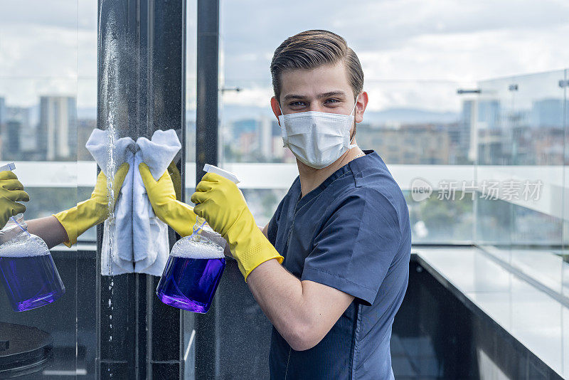 Man doing cleaning work in a building in times of pandemic caused by the COVID-19 quarantine